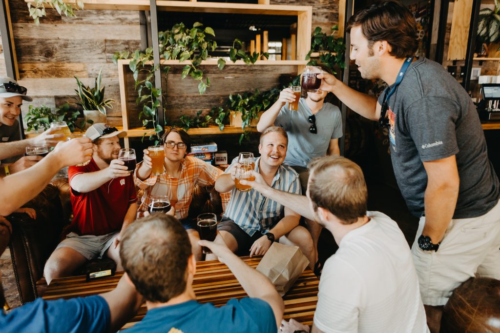 Men cheers in a boho brewery