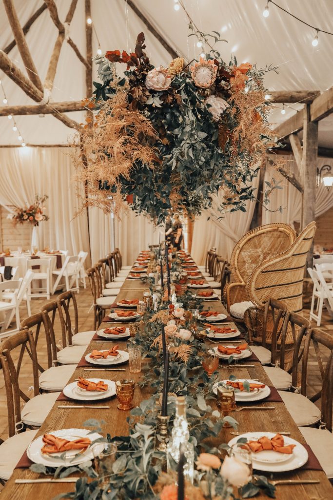 Beautiful and unique floral installation over a head table.